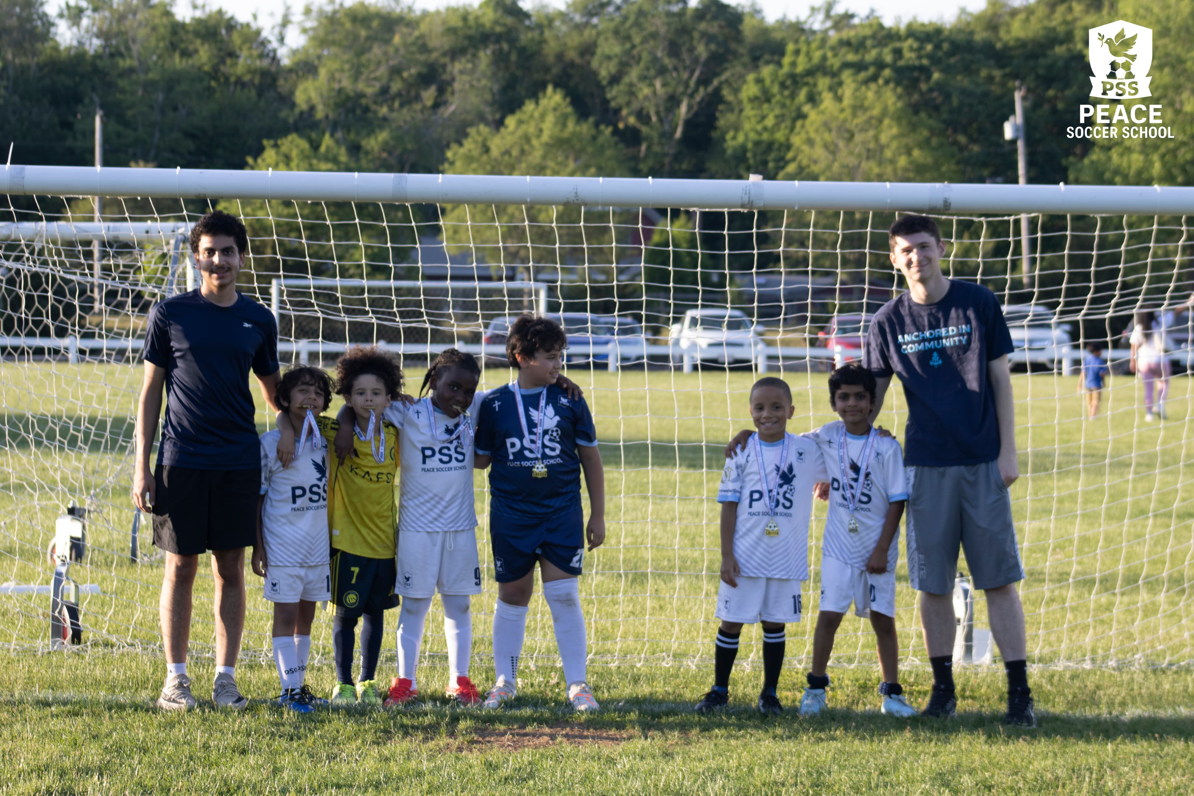 Kids running soccer drills in PSS gear at faith-based soccer academy