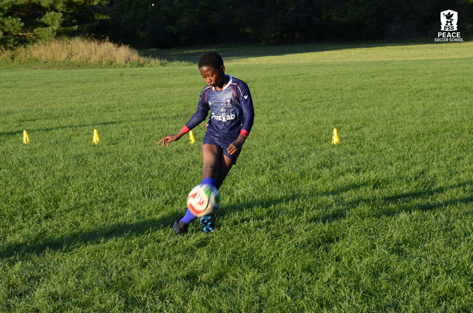 A PSS player dribbling through cones